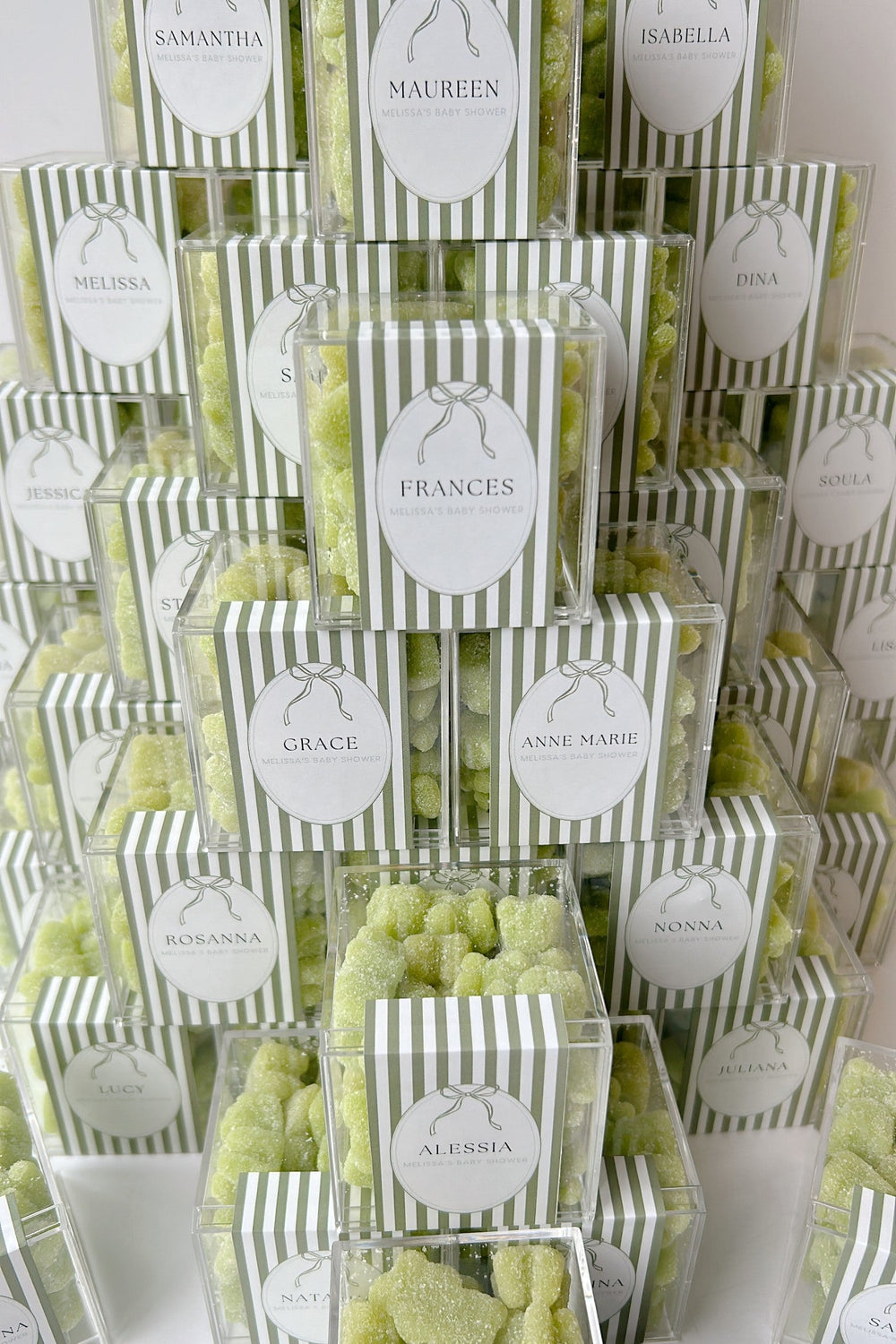 Image of candy boxes for a baby shower with green gummy bears and personalized label