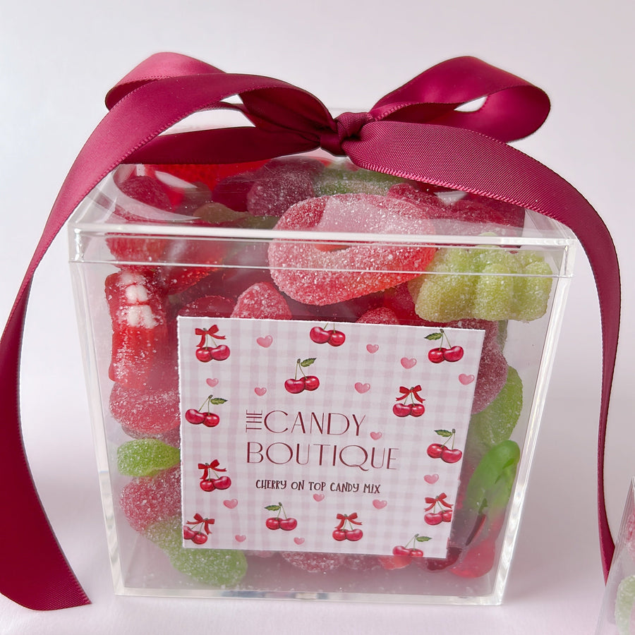 clear candy box filled with cherry themed candy