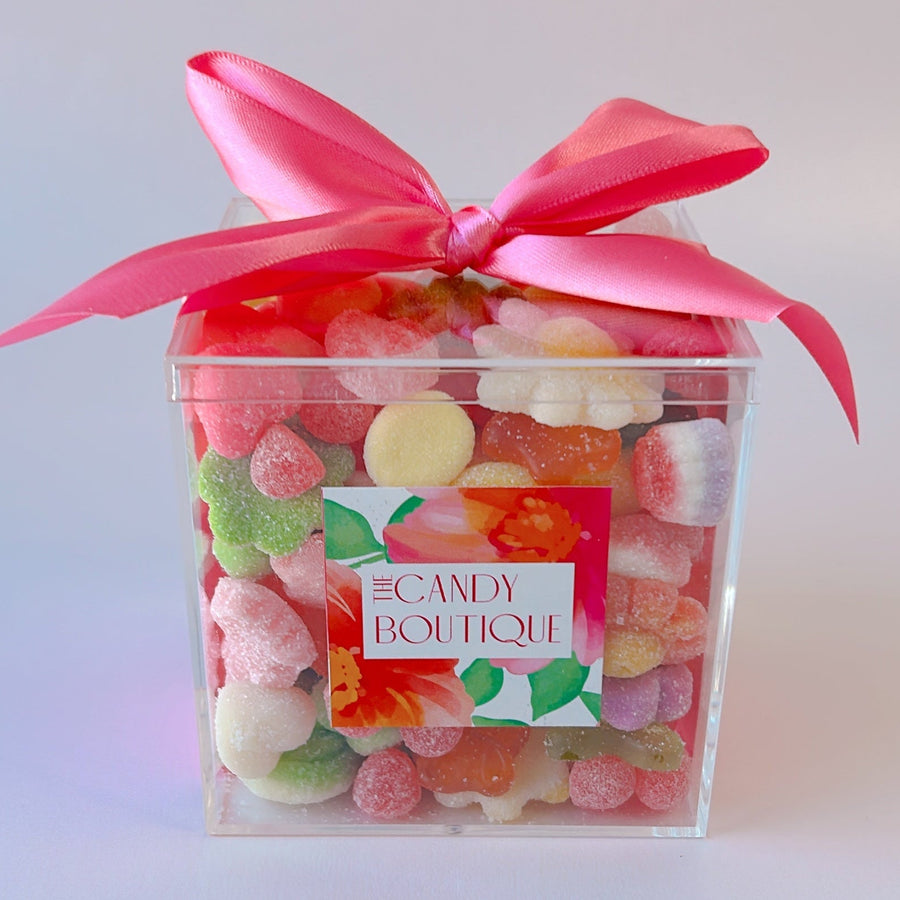clear container with a variety of flower shaped candy