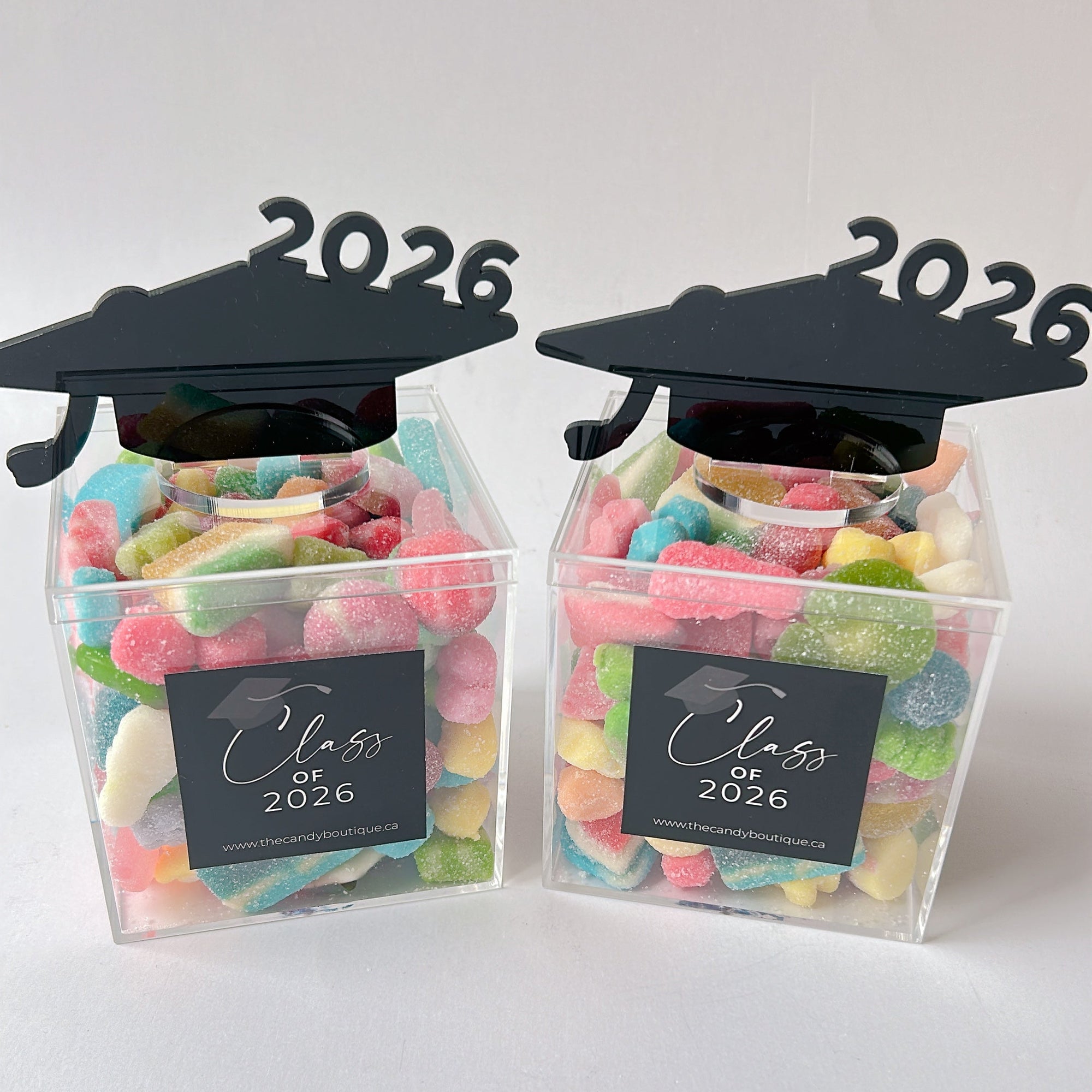Clear candy box filled with assorted candy and 2026 black grad cap on top