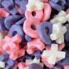 xo shaped gummies in pink purple and white