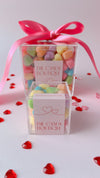 assorted heart shaped candy filled acrylic boxes
