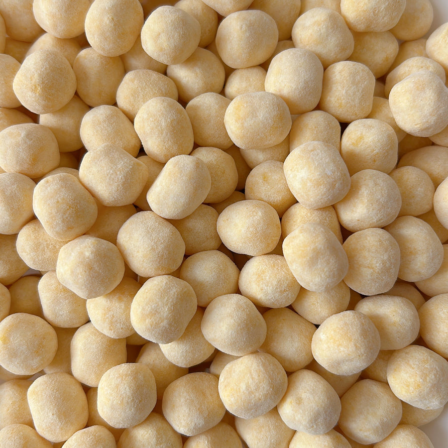 A close-up top-down view of pastel yellow bonbons 