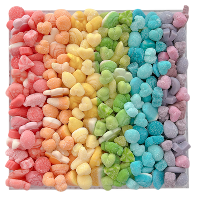 Colorful pastel gummy candy arranged in a rainbow pattern in an acrylic tray