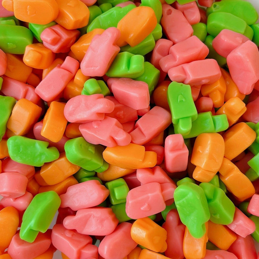 Colorful gummy bears in sherbet flavours of strawberry , green apple orange
