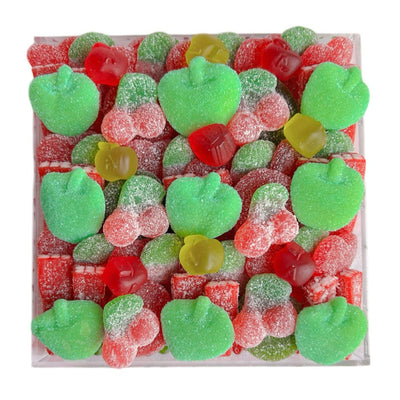 Assorted fruit gummies including green apple, red apple, shapes in an acrylic tray