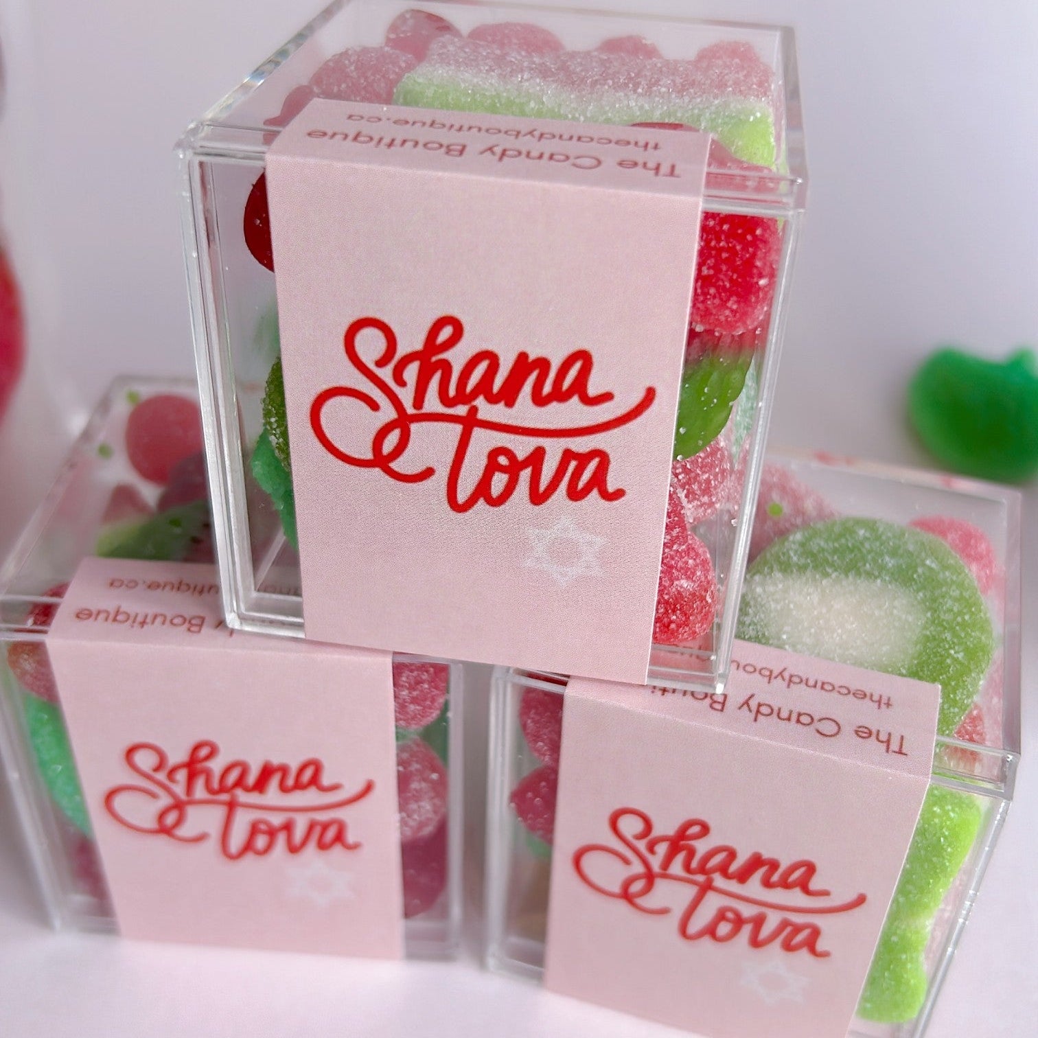 Acrylic candy boxes filled with red and green gummies