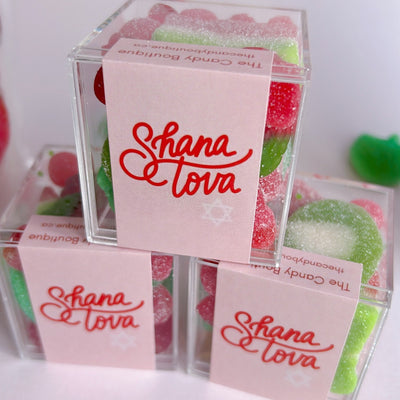 Acrylic candy boxes filled with red and green gummies