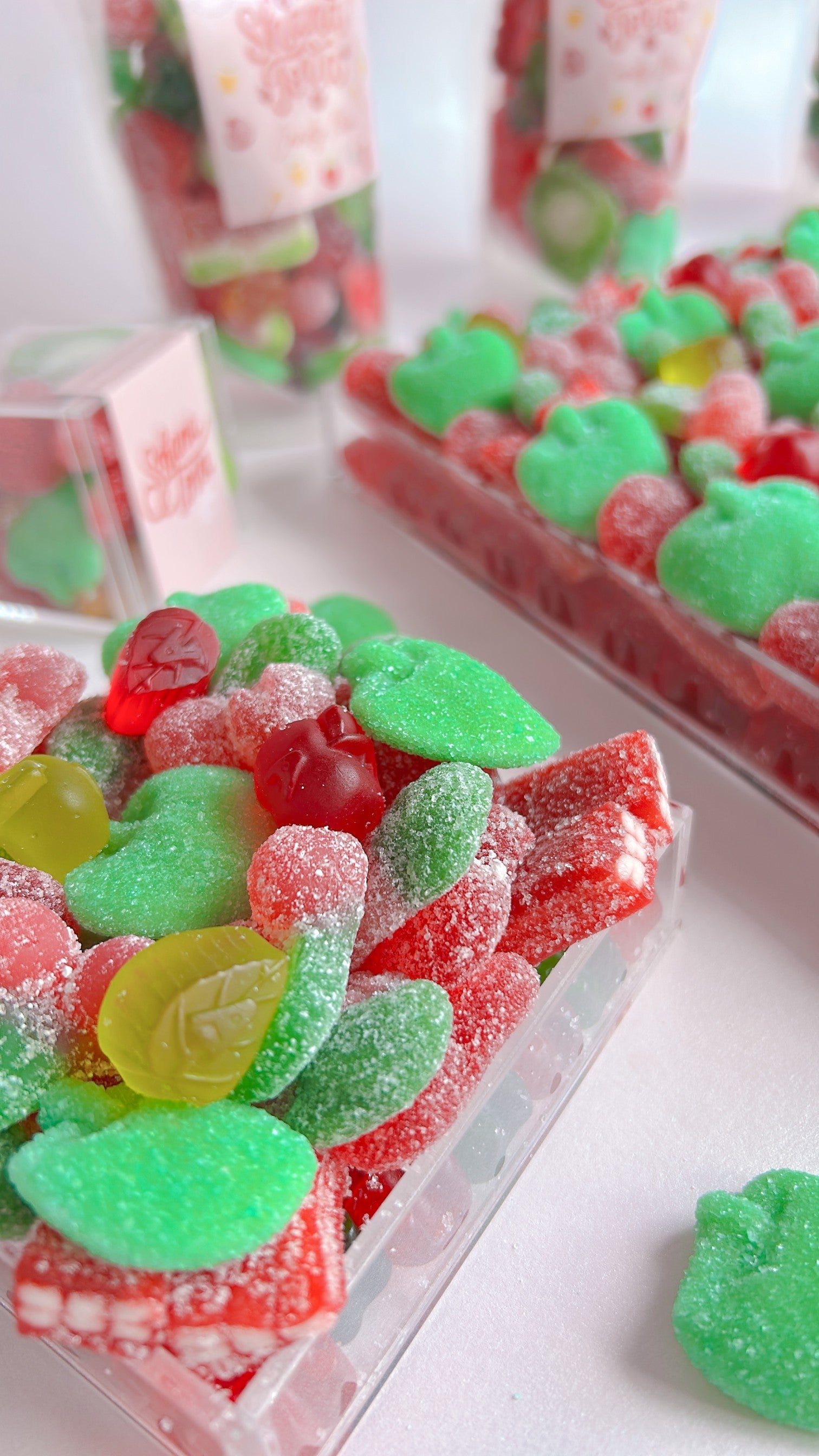 Colorful gummy candies in a clear acrylic tray