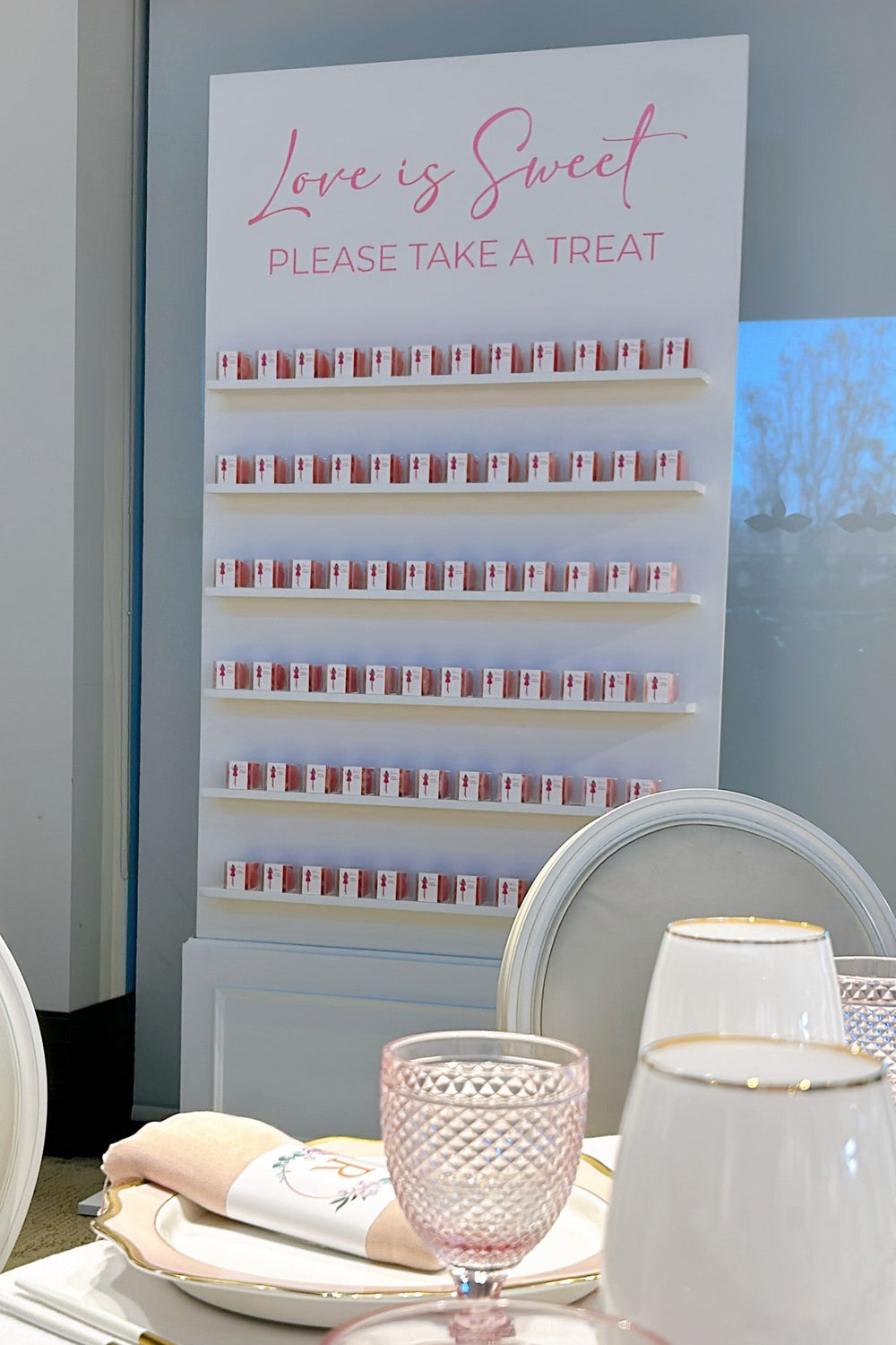 Image of candy wall with candy boxes displayed on each shelf