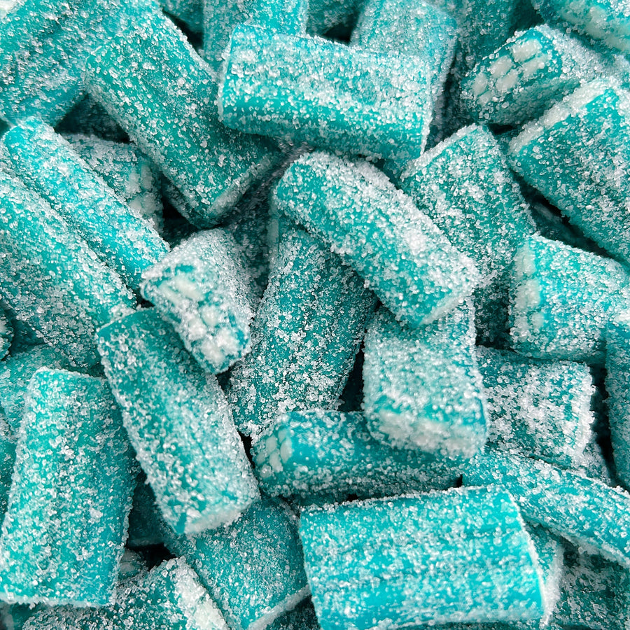 A close-up pile of blue rectangular candies coated in white sugar crystals