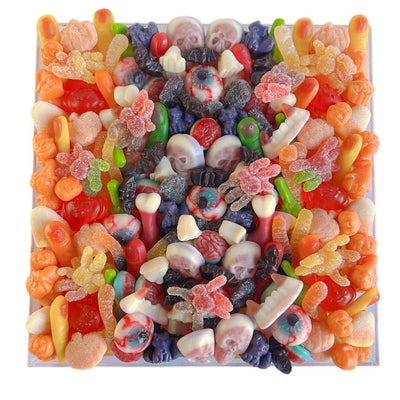 Colorful halloween-themed gummy candy in a large acrylic tray