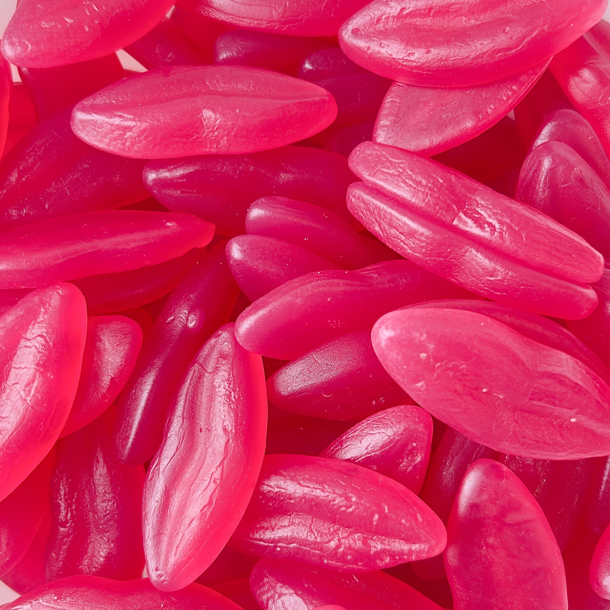 A pile of pink candy pieces shaped like lips