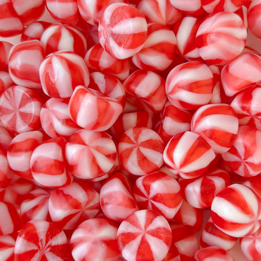 a pile of white and pink swirl candy 