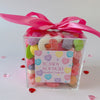 Mix of pastel coloured gummy candy in a large candy box