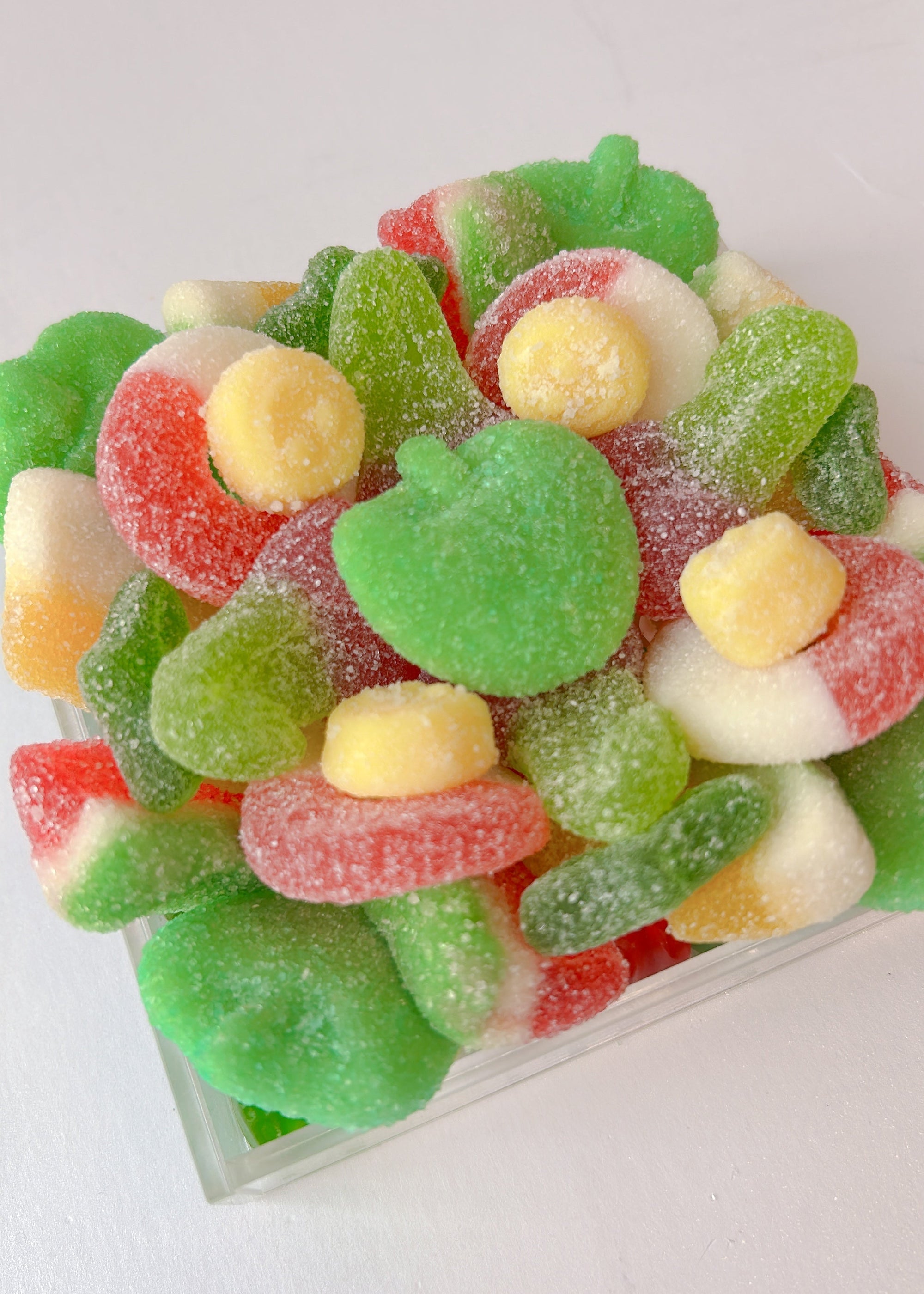 Assorted colorful gummy candies nestled in a clear tray