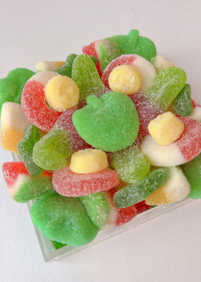 Assorted colorful gummy candies nestled in a clear tray