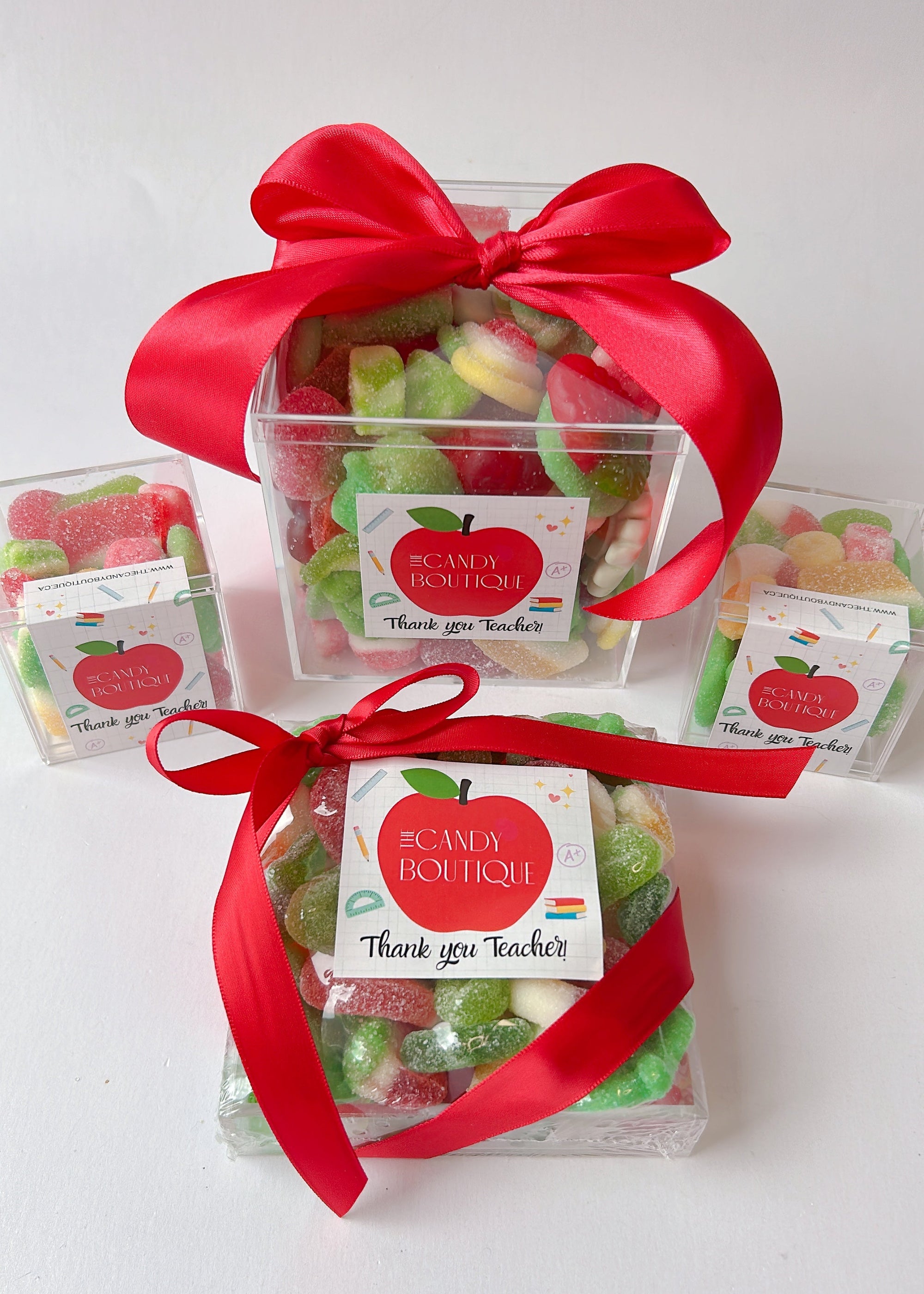 Clear trays and boxes filled with gummy candy with 'Thank you Teacher' labels