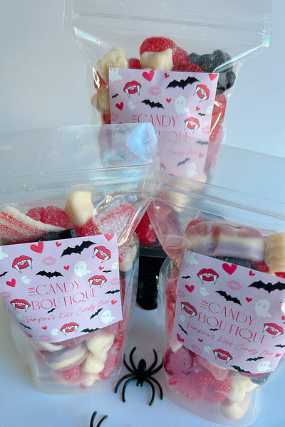 Halloween-themed candy bags with spider decorations on a white background