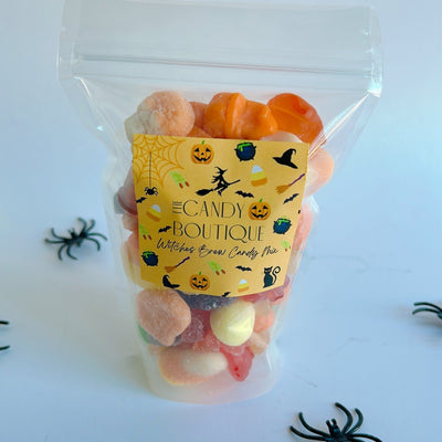 Packaged Halloween-themed candy with a yellow label on a white background with spider decorations.