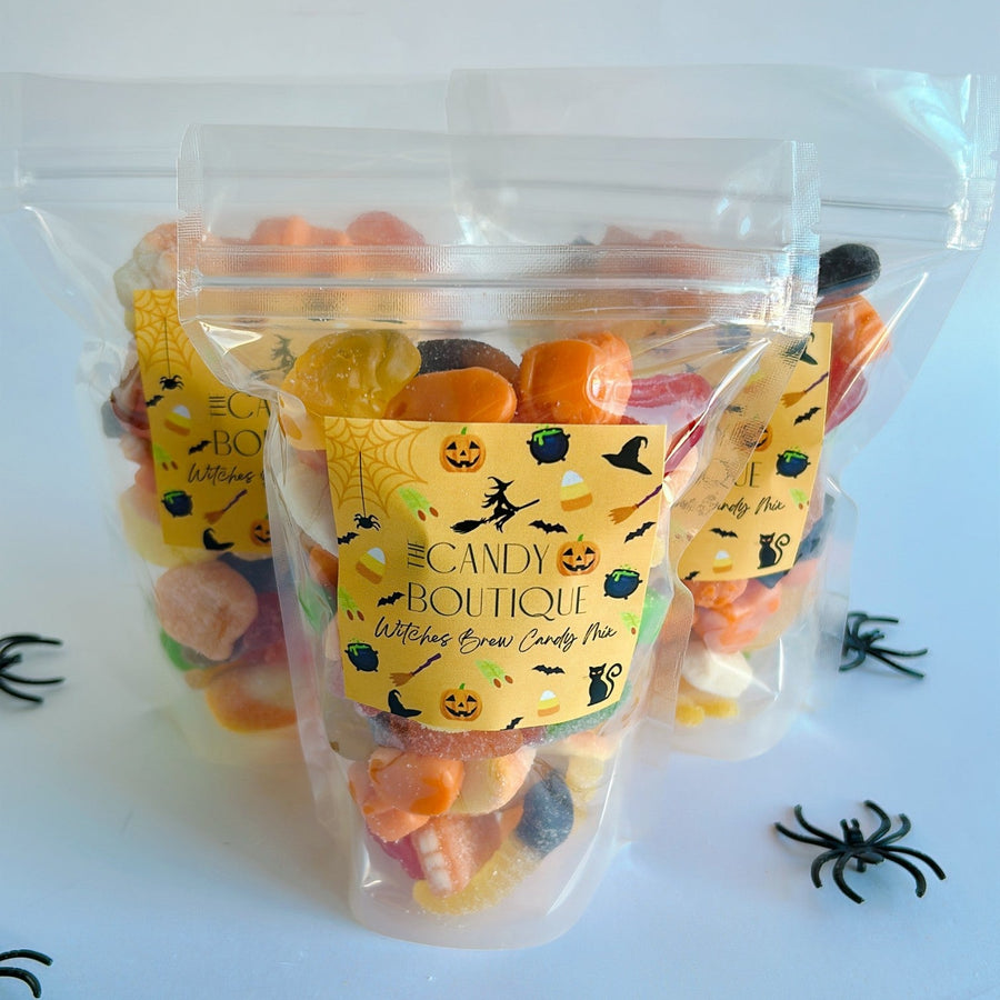 Bag of Halloween-themed candy with a label on a white background with spider decorations.